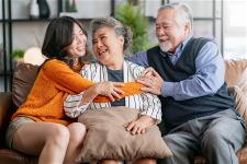 happiness-asian-family-candid-daughter-hug-grandparent-mother-farther-senior-elder-cozy-relax-sofa-couch-surprise-visiti